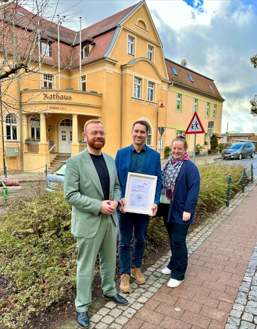 Zertifikatsübergabe vor dem Rathaus zur Förderung von "Unsere Grüne Glasfaser" für schnelles Internet im Ort.